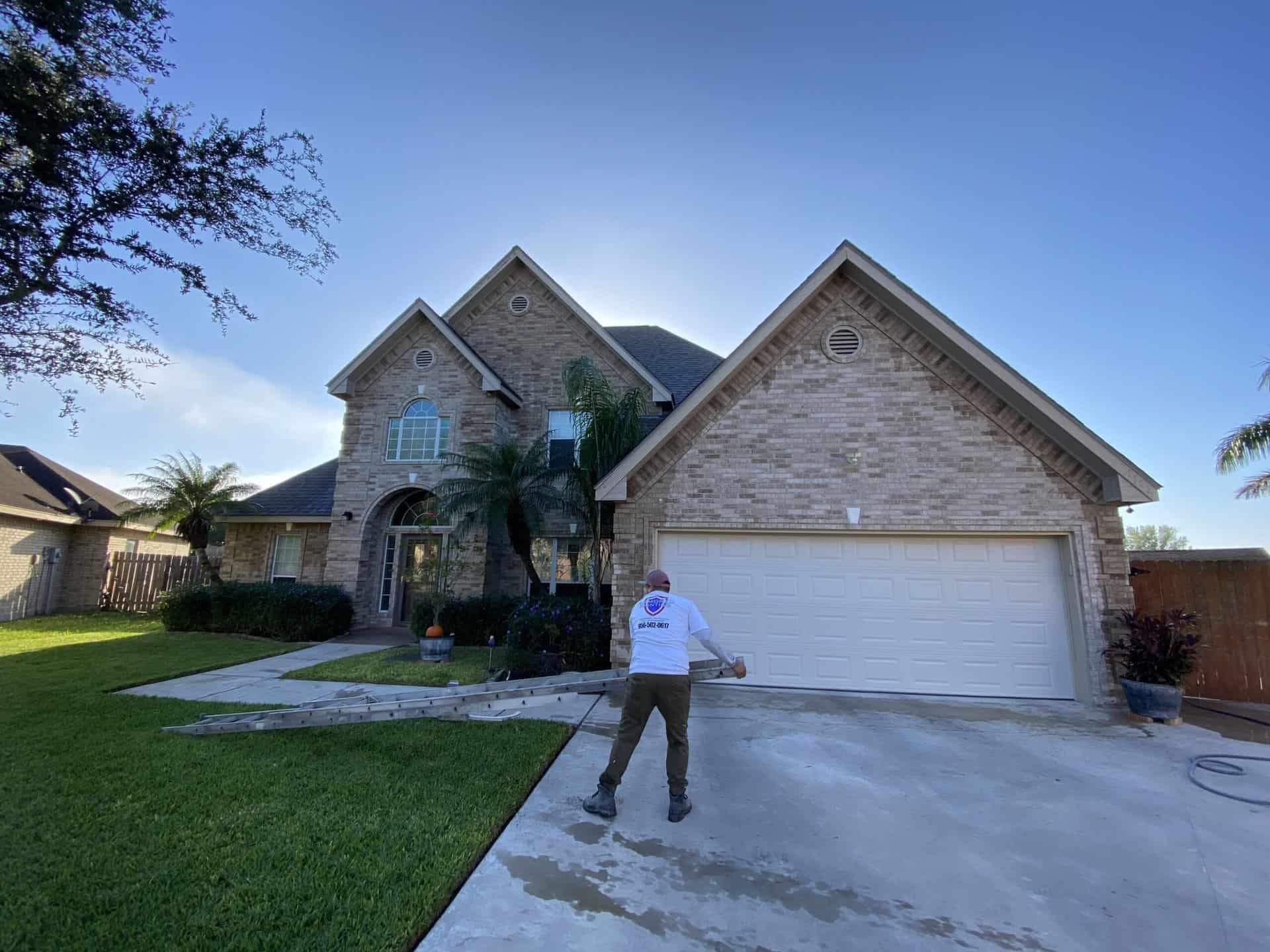 Brick home driveway during a pressure washing service call