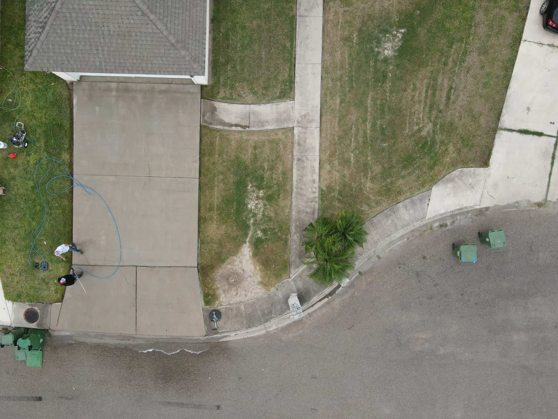 Aerial view of a driveway half pressure washed
