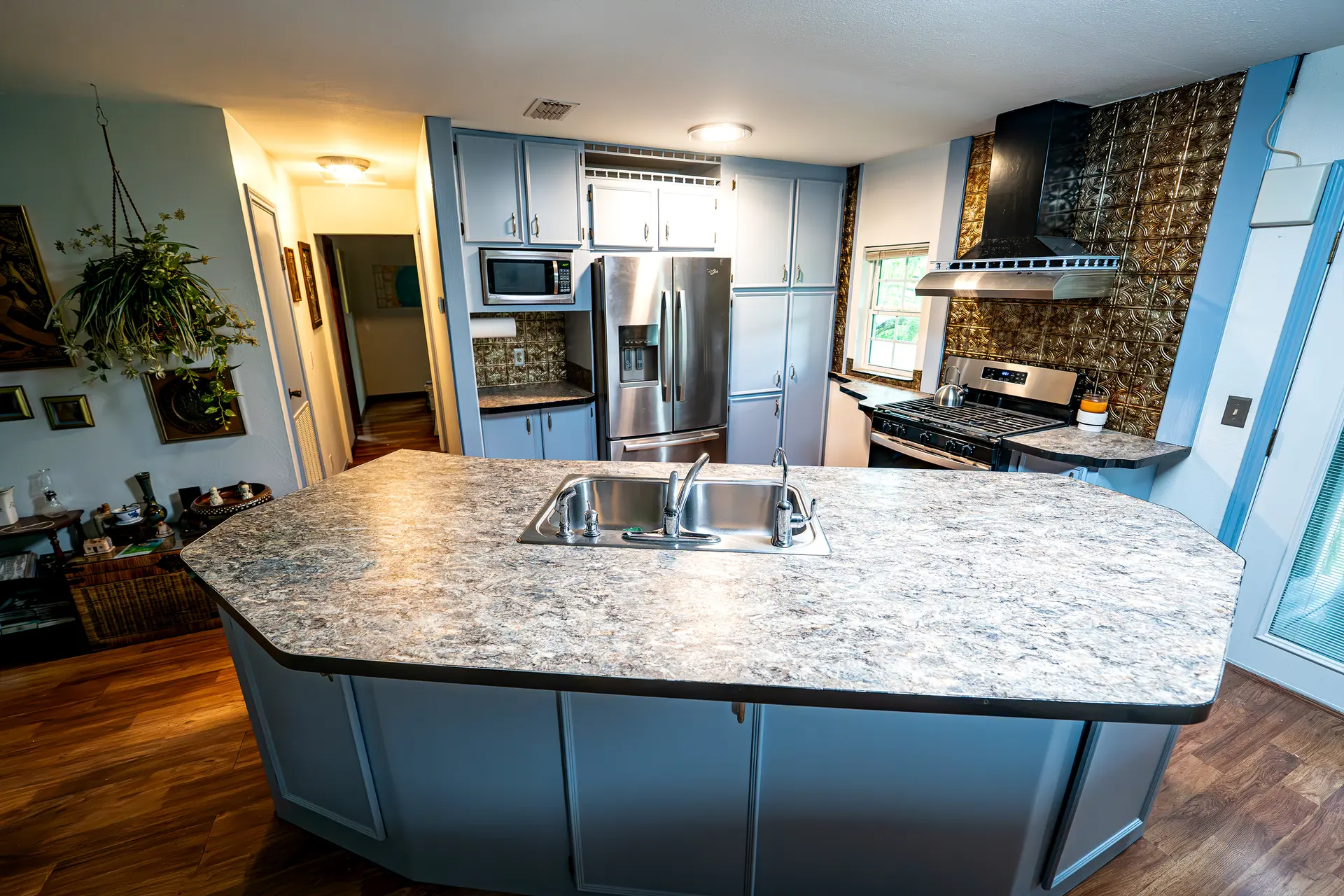 Blue-gray refinished kitchen island and perimeter cabinets