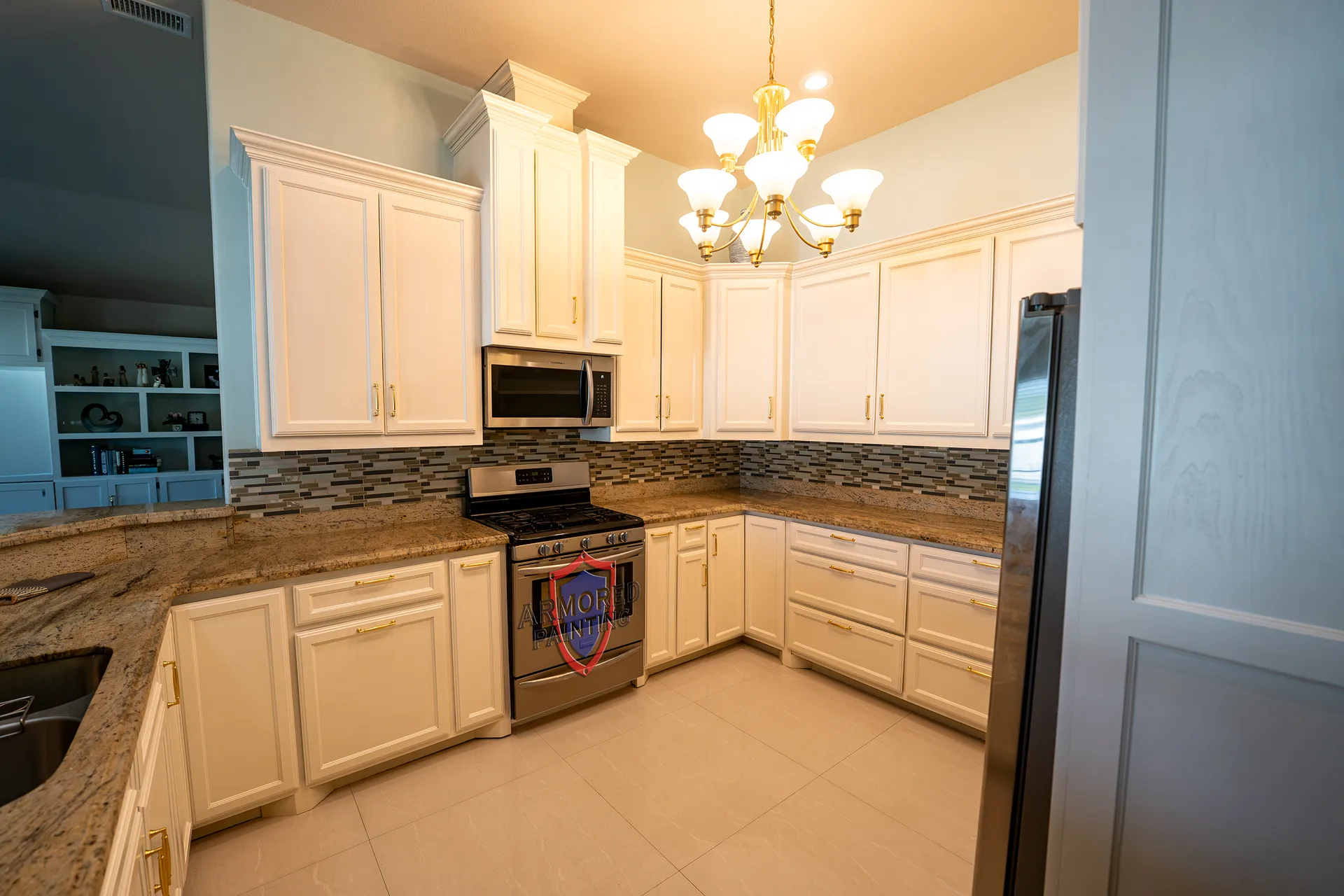 Cream refinished kitchen cabinets with granite counters