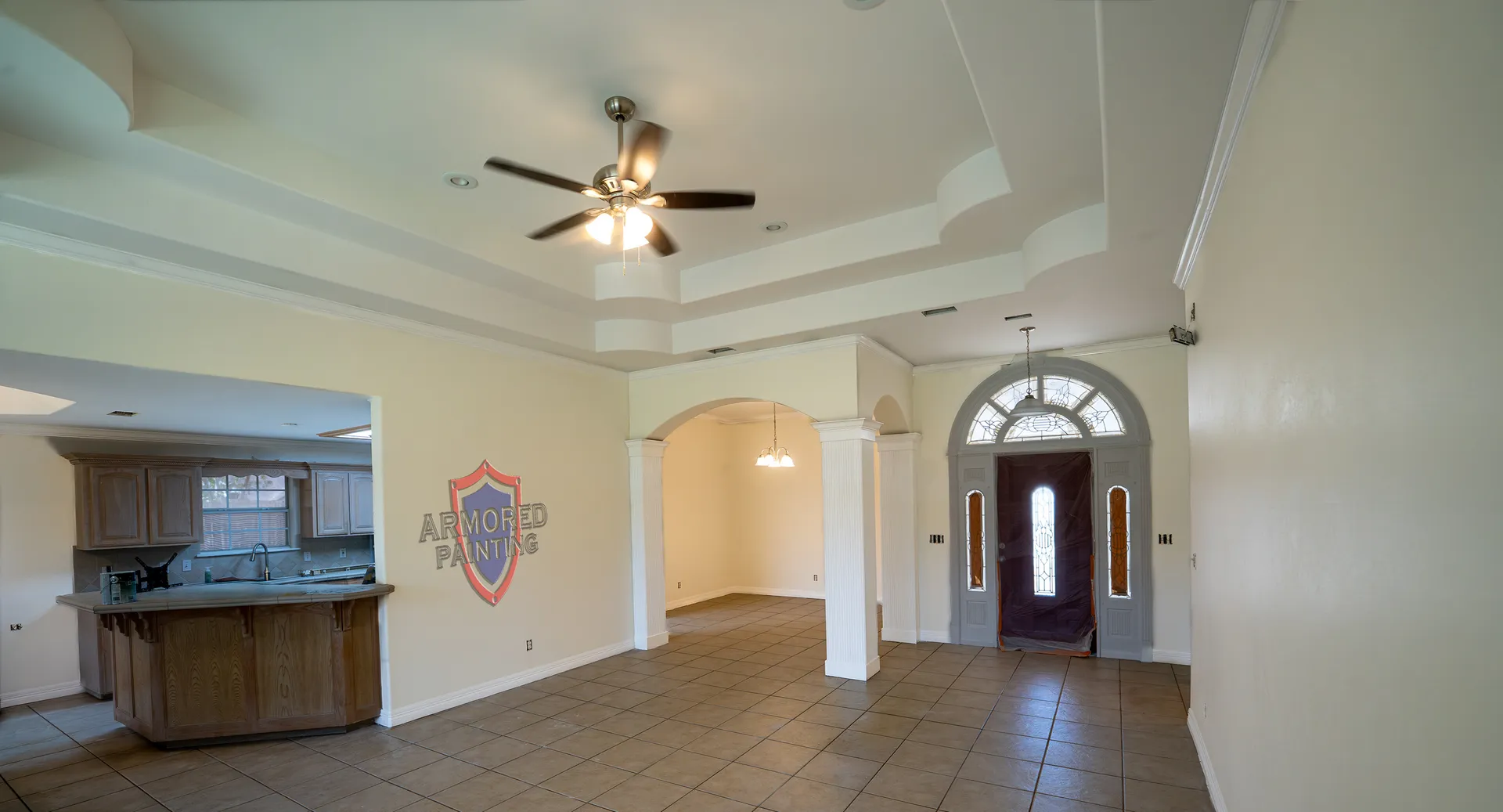 Freshly repainted open-concept living room with tray ceiling