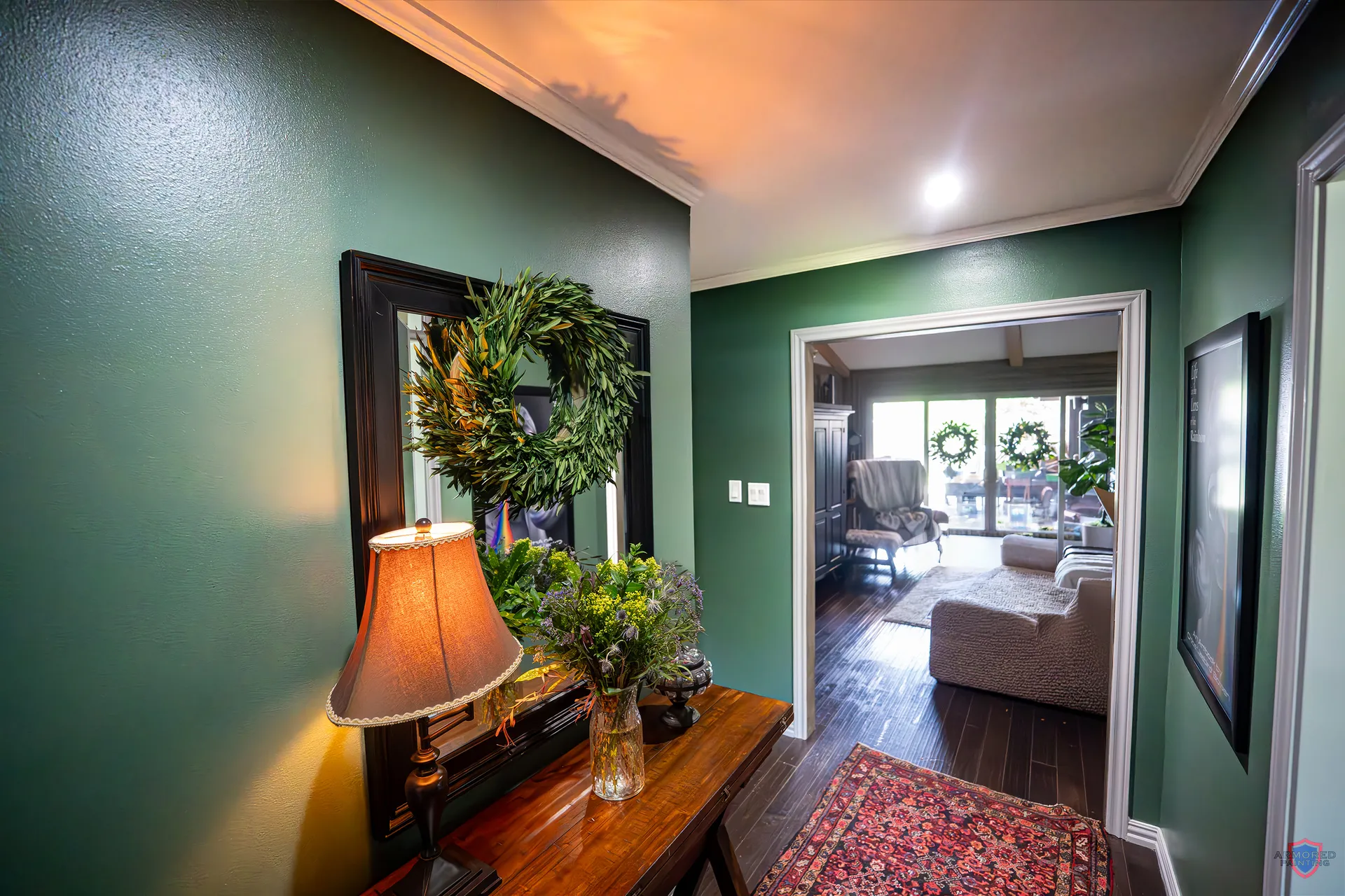 Entry hallway with a deep green accent wall after interior painting